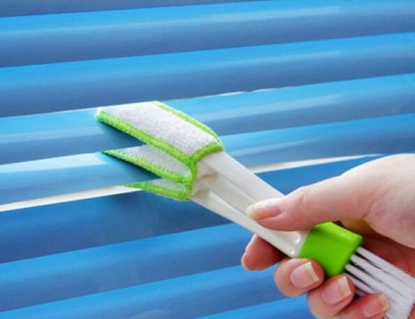 Person holding a Double Head Cleaning Brush for effective dusting in a car interior.