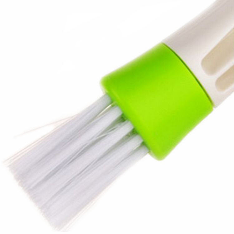 Person holding a Double Head Cleaning Brush for effective dusting in a car interior.