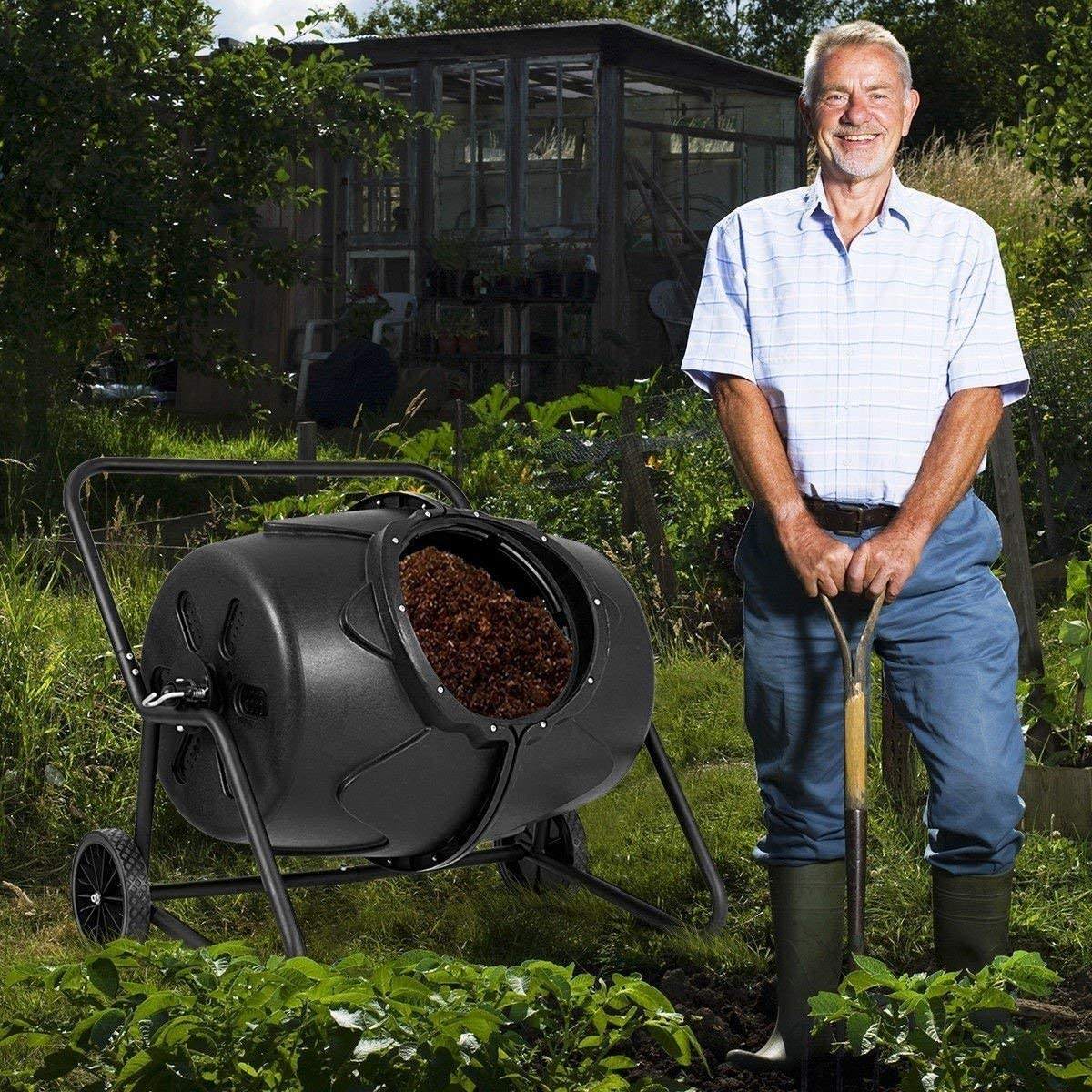 Person adding kitchen waste into a Removable Rotary Compost Bucket for efficient composting in a garden.
