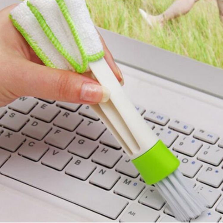 Person holding a Double Head Cleaning Brush for effective dusting in a car interior.