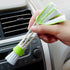 Person holding a Double Head Cleaning Brush for effective dusting in a car interior.